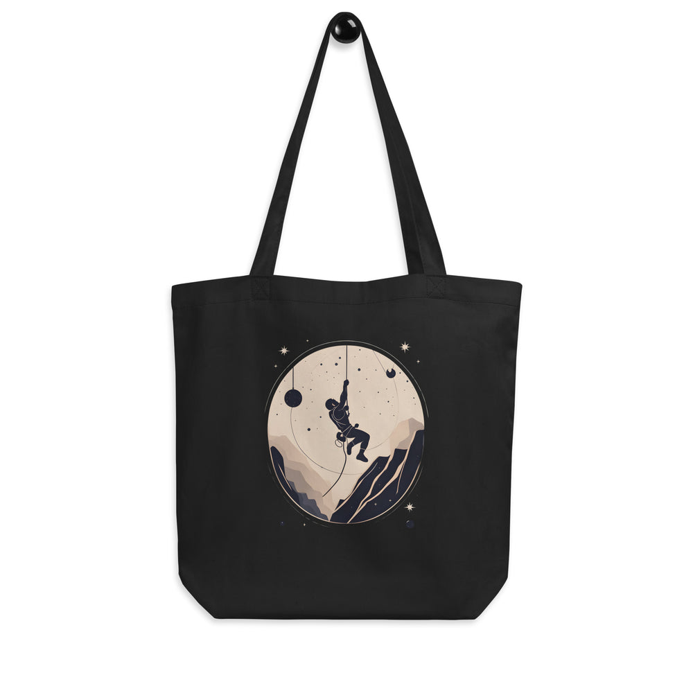 Black tote bag with art showing a rock climber ascending up a rope