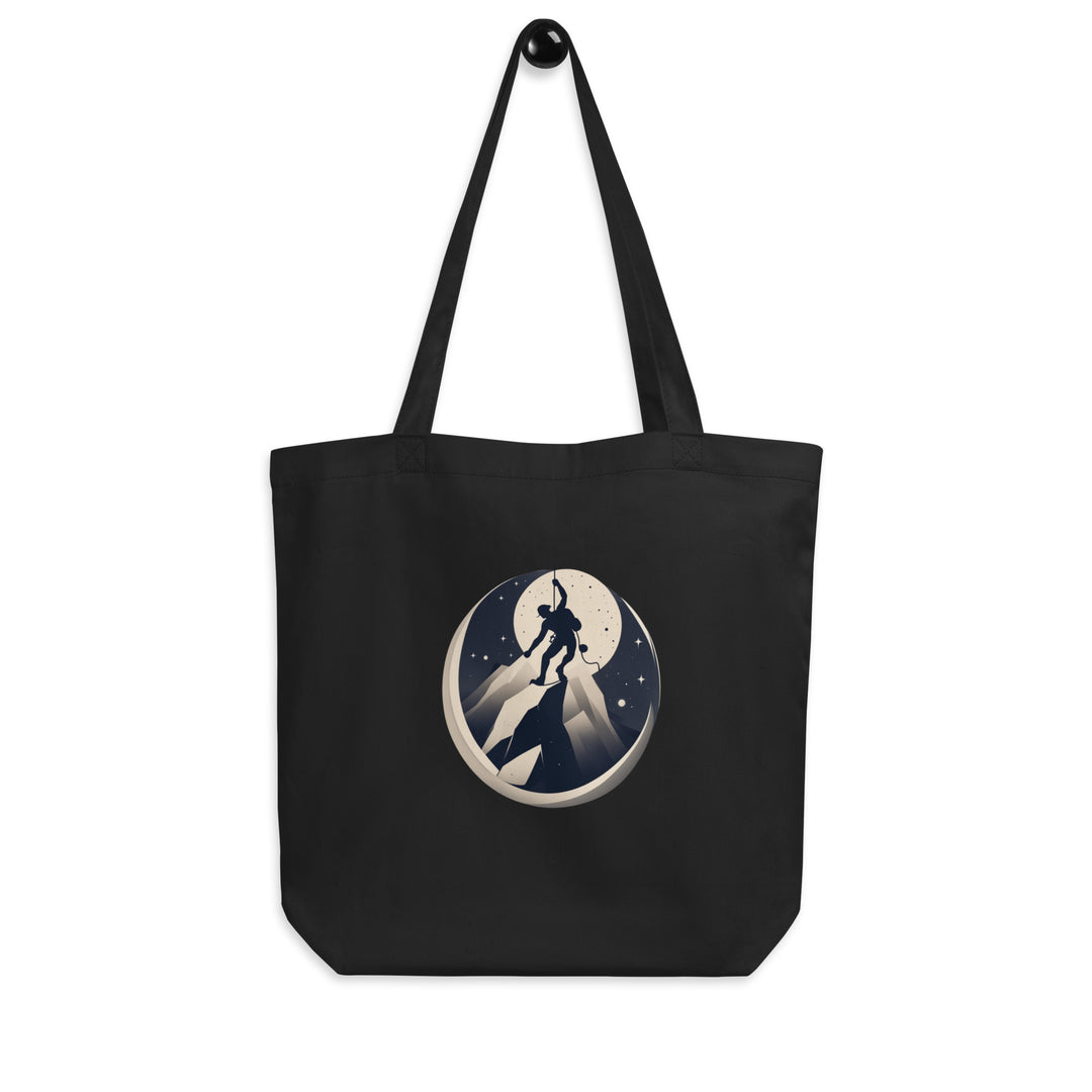 Black tote bag picturing a climber getting to the top of a mountain